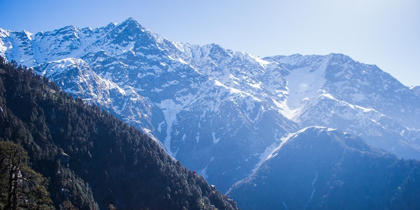 An image showing Dharamkot in Dharamshala, Himachal Pradesh, India, with hillside views.