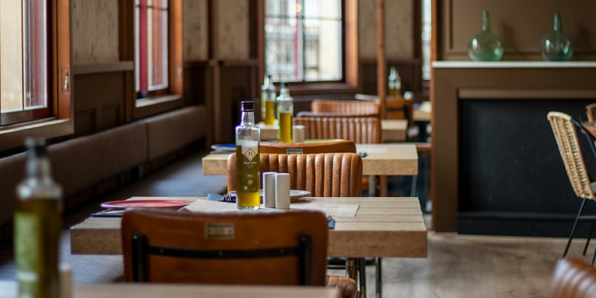 Modern and cozy cafe sitting similar to Diosa Del Cafe with wooden accents, soft lighting.
