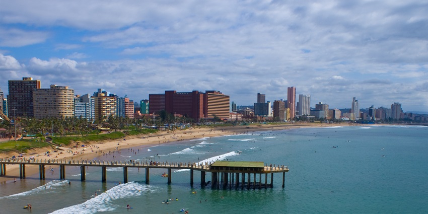 Visitors walking on the walkway at the beachfront area of Durban Beach during the day