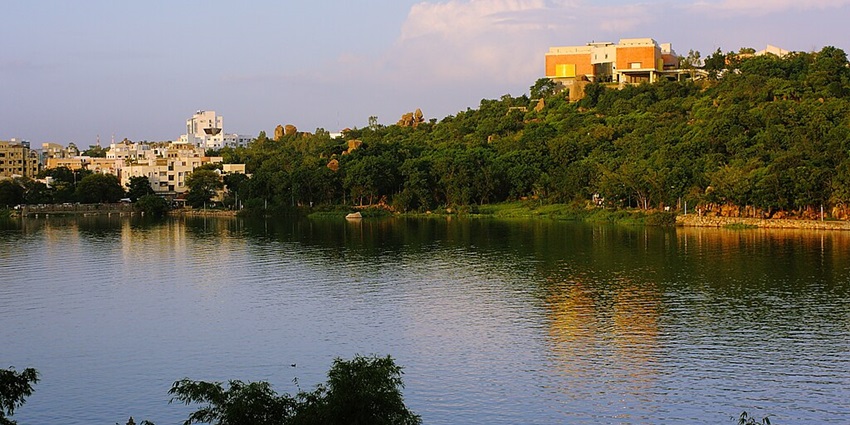 Scenic view of Durgam Cheruvu Lake with surrounding greenery in Hyderabad.