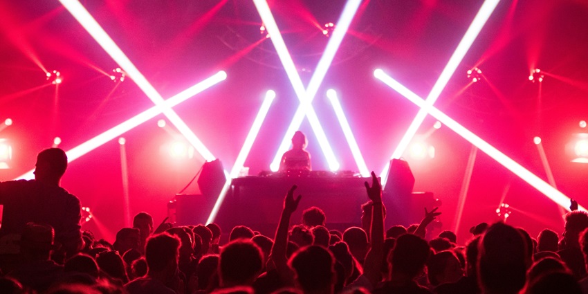 Partygoers dancing under neon lights similar to EON Club, enjoying music and nightlife