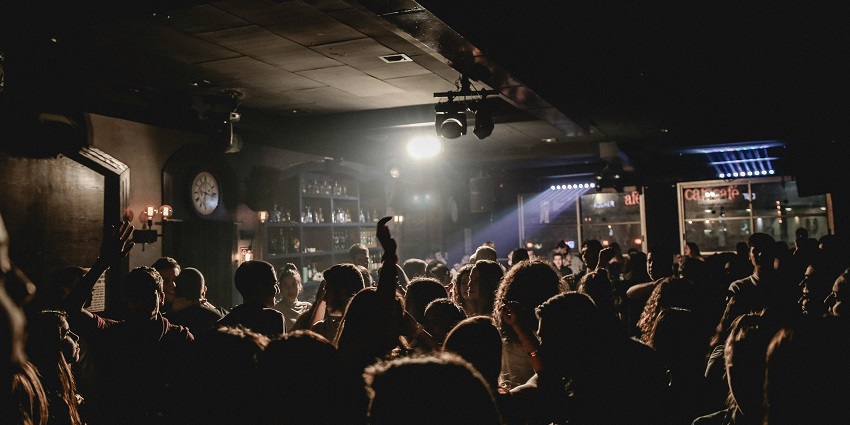A vibrant club playing reggaeton, salsa, and merengue, creating a non-stop party atmosphere