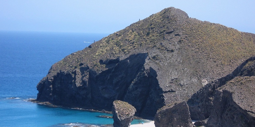 El Muerto Beach, nestled beneath steep rocky cliffs is one of the nude beaches in Spain.