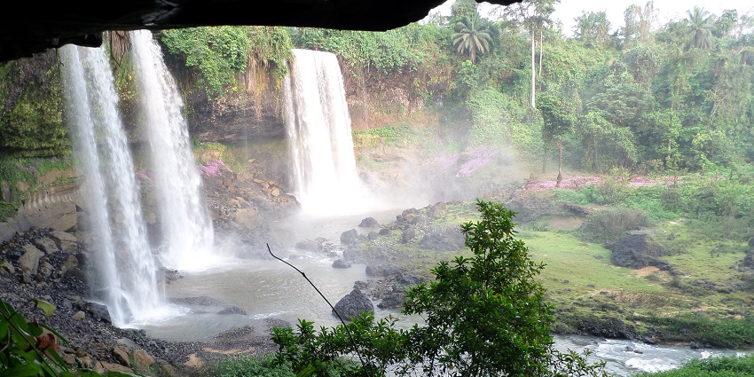 Agbokim Waterfall Nigeria seen in all its glory, surrounded by greenery and rocky terrain.