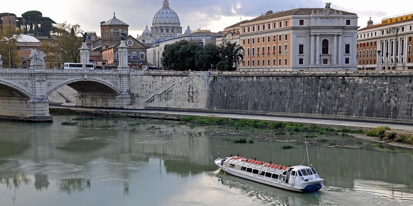 Visitors exploring Tiber River on a boat, one of the unique things to do in Rome.