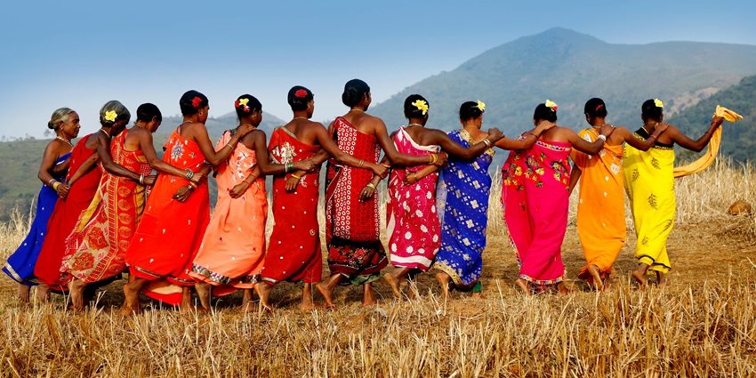 A group of Goan women in traditional attire perform the traditional Fugdi Dance on a stage