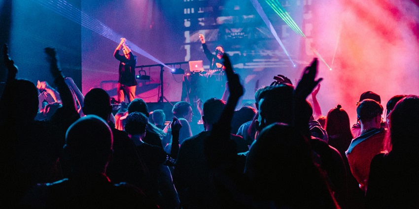 Image of cultural program going on and people enjoying the music and vibe at night