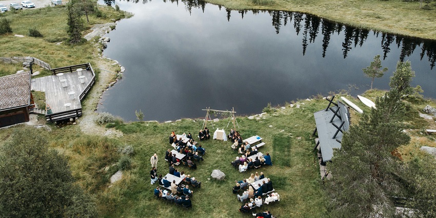A lakeside picnic with people seated in an outdoor setting similar to Ulsoor lake