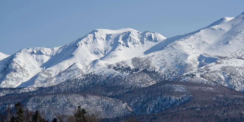 Winter adventure exploring floating sea ice and snow capped mountains in Shiretoko.