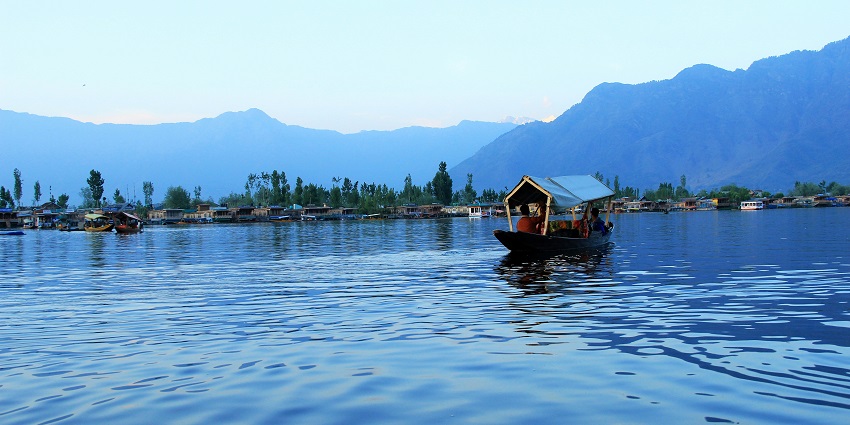 A man and a boy row a Shikara boat at Dal Lake in Jammu and Kashmir’s Srinagar.