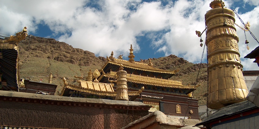 A serene Kora pilgrimage path winding around sacred sites, lined with prayer flags