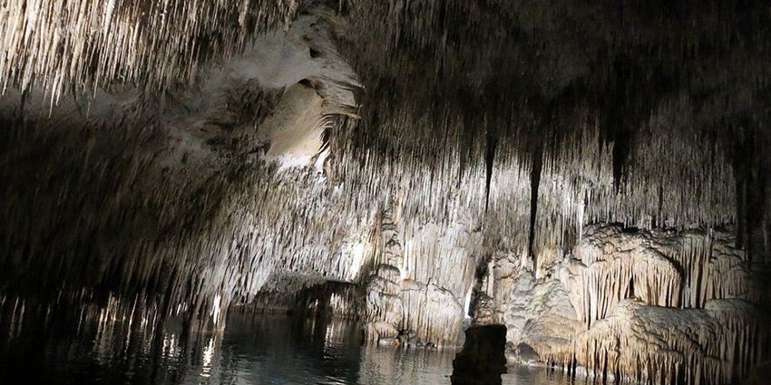 Drift across one of the world’s largest underground lakes in a surreal setting.