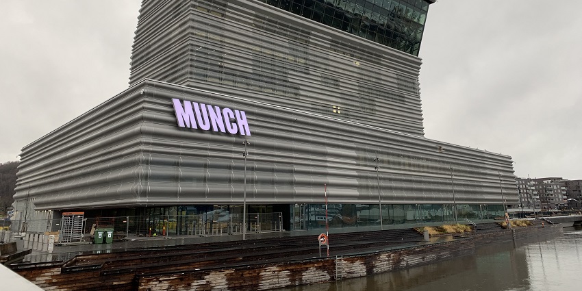 An image of the Munch Museum in Oslo featuring its modern architecture and prominent "MUNCH" sign.