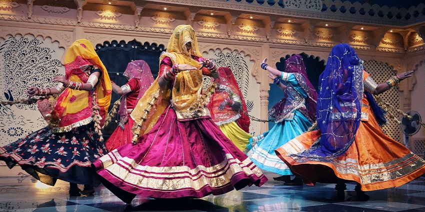 Rajasthani folk dancers dressed traditionally, performing the traditional dance of Rajasthan.