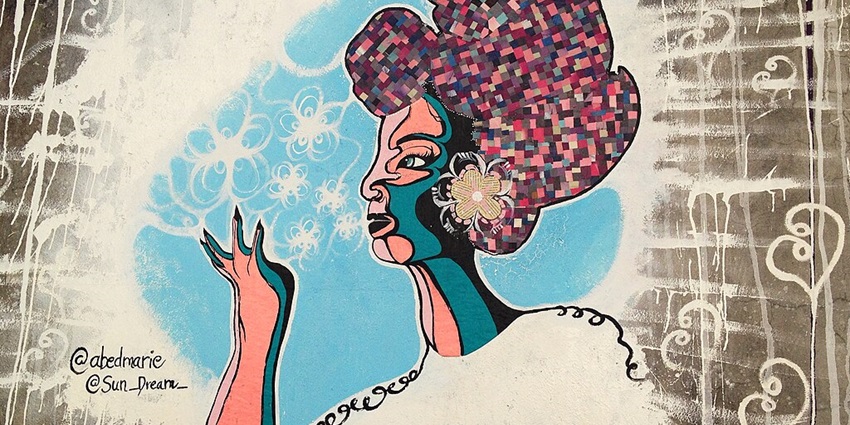 Colorful street art mural of a stylized woman with a mosaic headdress in Puerto Rico