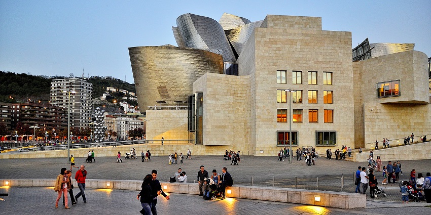 Visitors sitting and simply people-watching on the premises of the Guggenheim Museum.