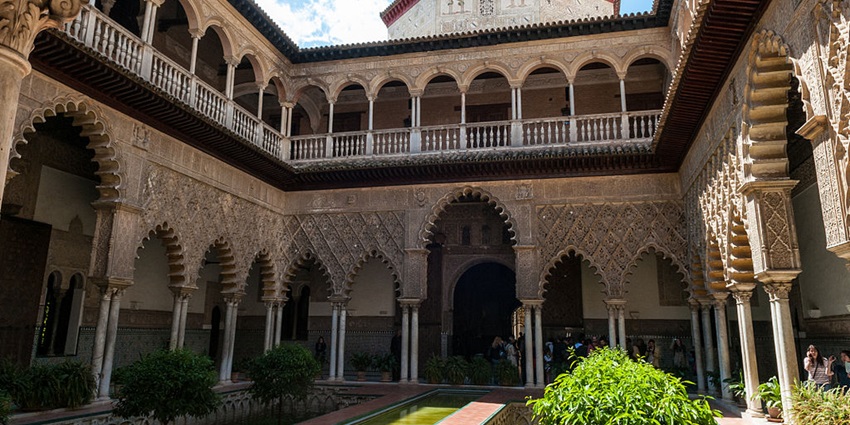 Tourists click images of Alcazar Palace, one of the fine things to do in Seville.