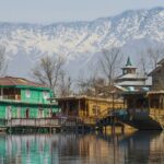 Houseboats on Dal Lake in Srinagar with several boats parked - Famous Lakes In Jammu And Kashmir