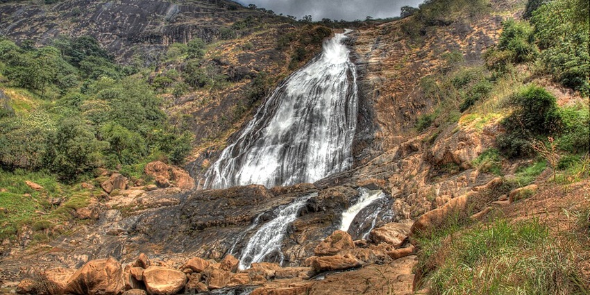 Nigeria waterfalls with breathtaking white torrents plunging from high cliffs into a serene valley.