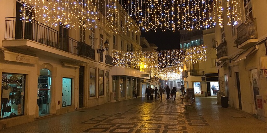 A few fairy lights tucked up in a lively street in Faro, a significant city in Portugal.
