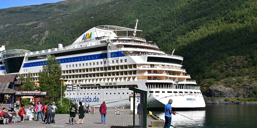 An image showing the picturesque village of Flåm, nestled amidst Norway's majestic fjords