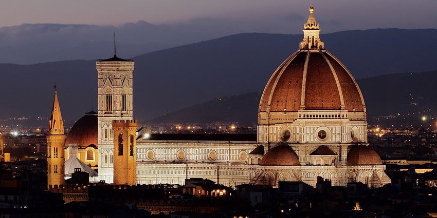 An image of Florence's Duomo at night, showcasing Brunelleschi's dome and the city skyline