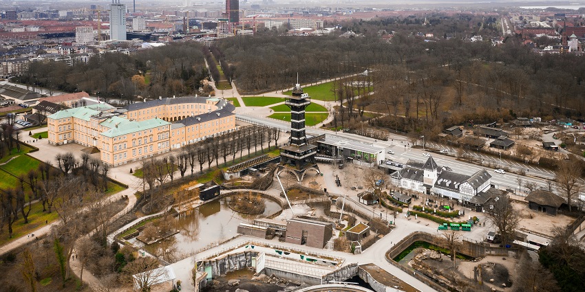 An Image of Frederiksberg in Denmark, with serene lakes and historic buildings in the day.