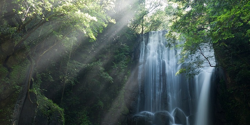 Beautiful waterfall cascading over cliffs into the sea.