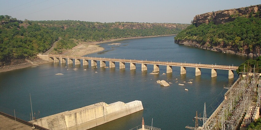 Gandhi Sagar Lake with a large water body, sandy shore and a bridge over the lake