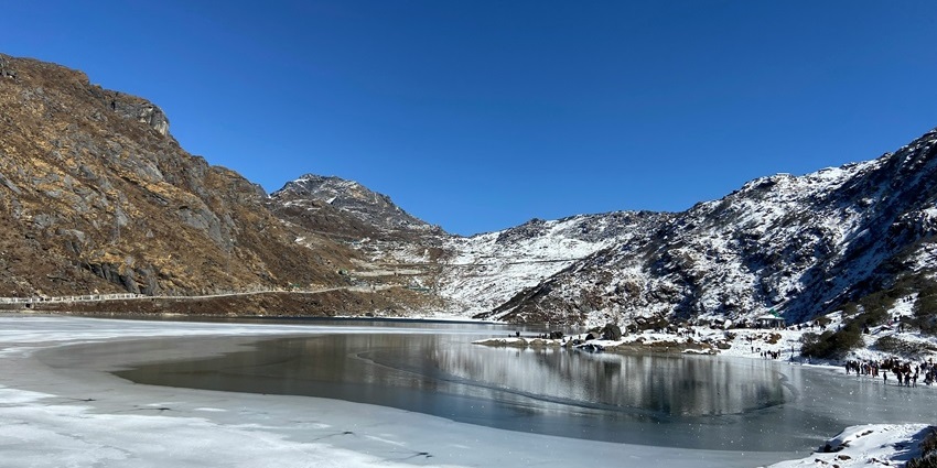 A breathtaking view of Gangtok featuring snow-capped mountains and serene lakes.