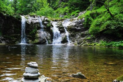 A picture of the serene Ghagra Waterfall surrounded by lush green forests in Jhargram.