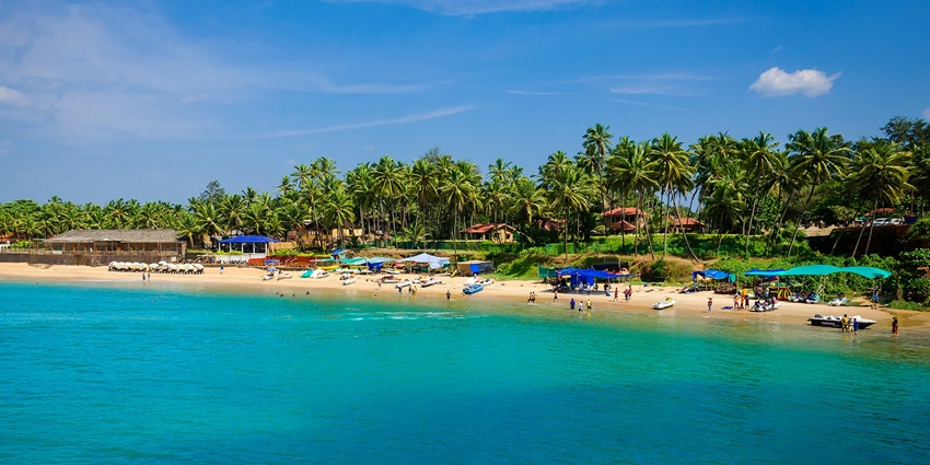 An image of Calangute Beach with people, a popular place to visit in January in India.