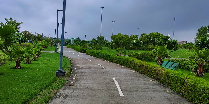 Lush Greenery and benches to sit at Gomti Riverfront Park near Anandi Water Park