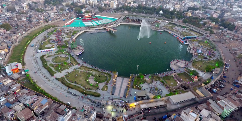 An image of Gopi Talav in Gujarat with a circular lake, greenery, and urban surroundings.