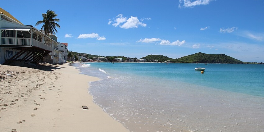One of the quiet, picturesque beaches in Saint Martin with calm waters and views of the surrounding hills.