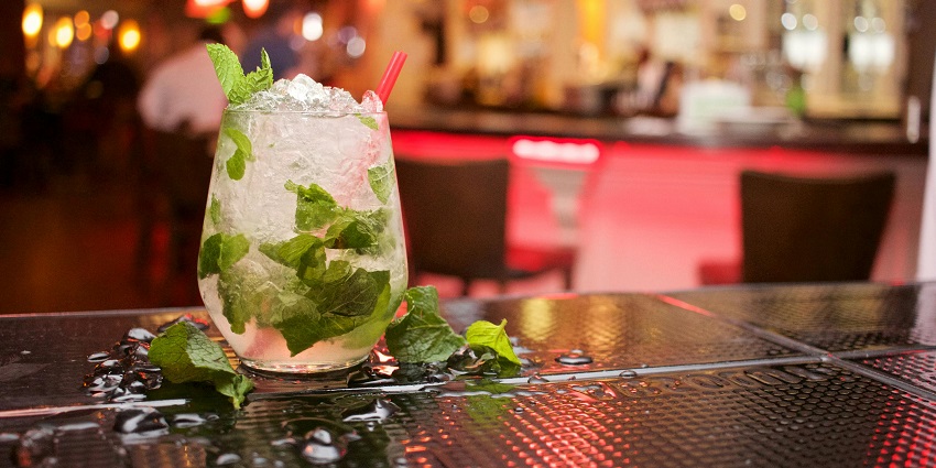 A trendy cocktail bar with innovative drinks, a chic crowd, and a stylish ambiance