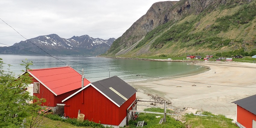 An image of Grøtfjord Beach, one of the beautiful beaches in Norway surrounded by mountains and clear waters.