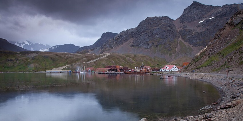 An image of Grytviken, a historic whaling station with a waterbody, and a small museum