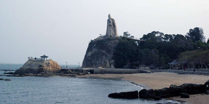 Gulangyu Island,beach in China with a statue of Koxinga on a rocky outcrop overlooking the sea.