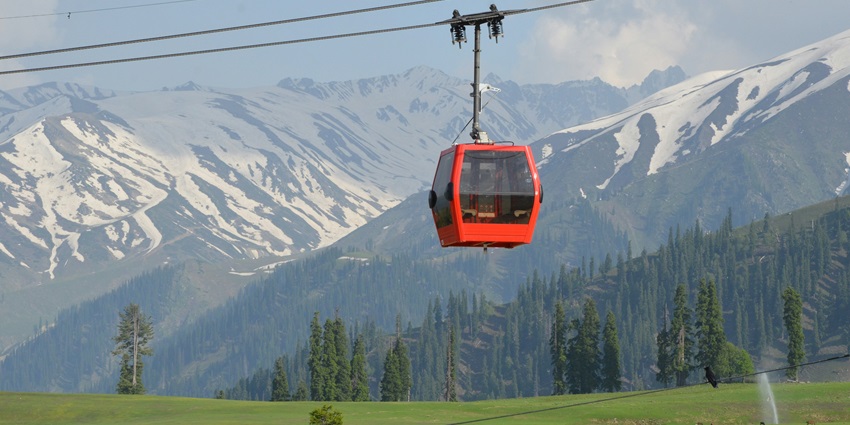 Gondola ride amidst the white blanket of snow and alpine forest in Gulmarg, Kashmir.