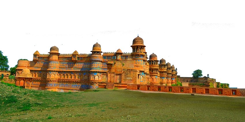An image of the historic Gwalior Fort, with intricate carvings, domes, and towers under a partly cloudy sky.