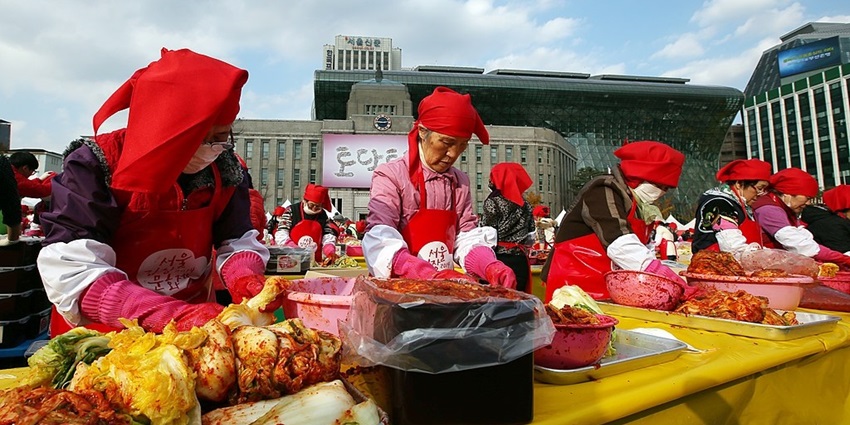 An image of large vats of kimchi being prepared at Gwangju Kimchi Festival in Korea.