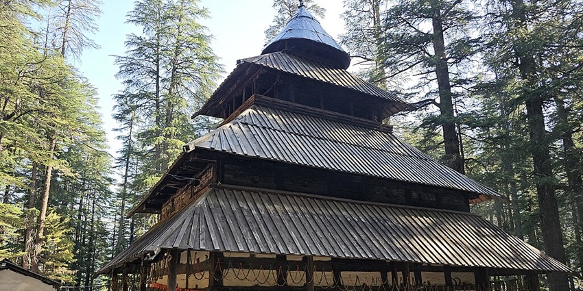 A corner view of a three-storeyed, hut-like Hadimba Temple in Manali, Himachal Pradesh.