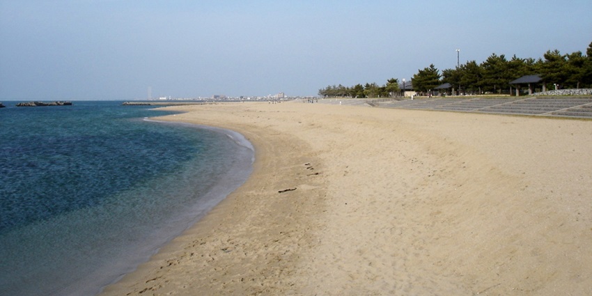 Family-friendly beach with shallow waters and scenic coastal views.