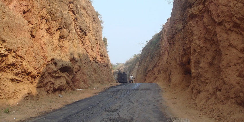 An Image of the Haldighati area, showcasing a narrow road between hills and a person.