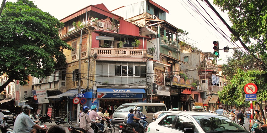 Bustling area with shops, eateries, and colonial architecture, featured in Hanoi city guide