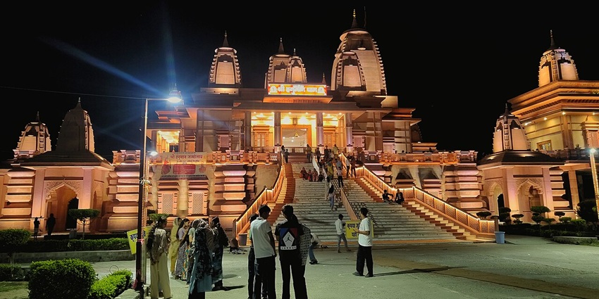 Explore the majestic Hanuman Dham temple with a grand entrance and a deity statue.