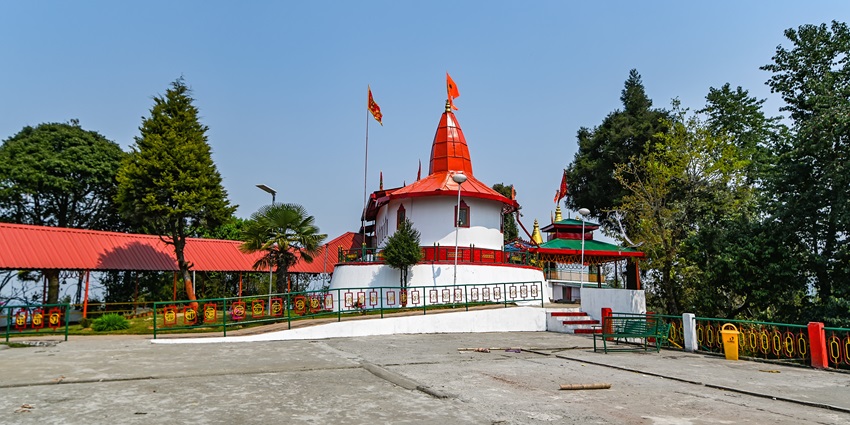 Hanuman tok with traditional architecture, red roofs and red flags on top of the temple