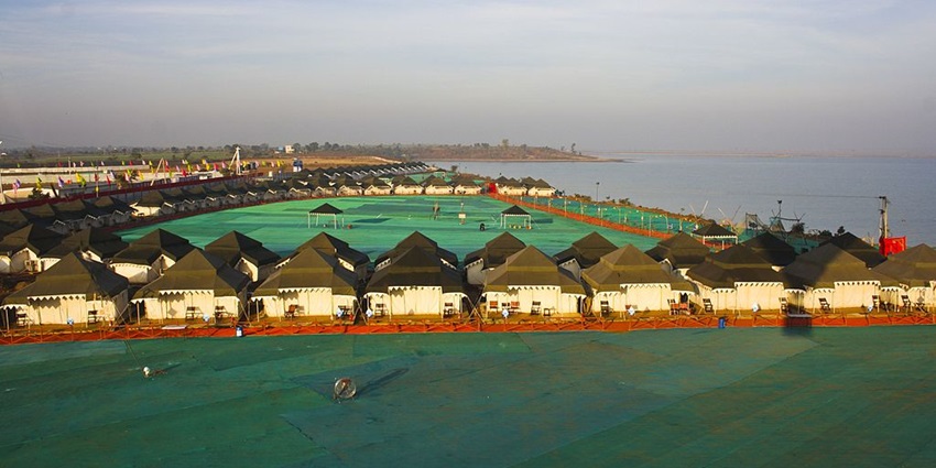 Tent city of Hanuwantiya from above with a large water body and Jal Mahotsav celebration