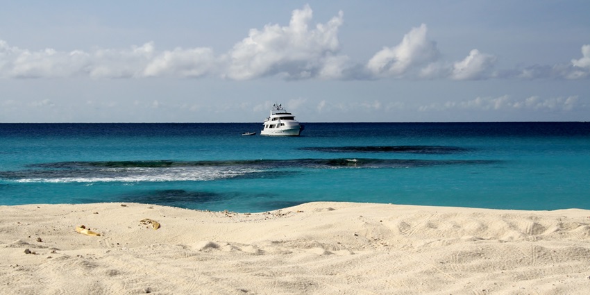 A secluded beach with calm waters, perfect for a relaxing day by the sea.
